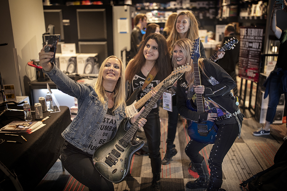 Guitarist Nita Strauss takes a selfie with fans at Guitar Center Hollywood. Photo by Ryan Hunter